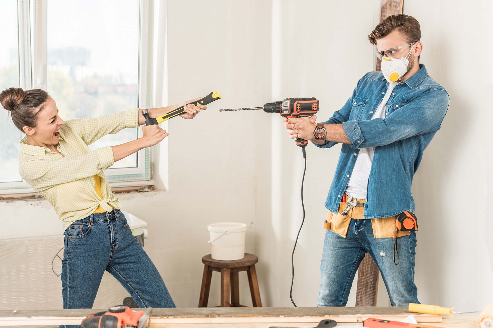 Young couple acting playful during home renovation project